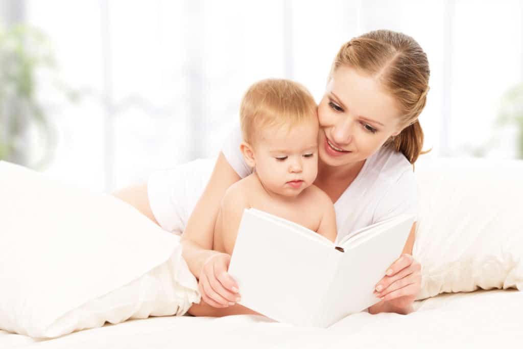 Reading books to encourage cognitive development in infants.