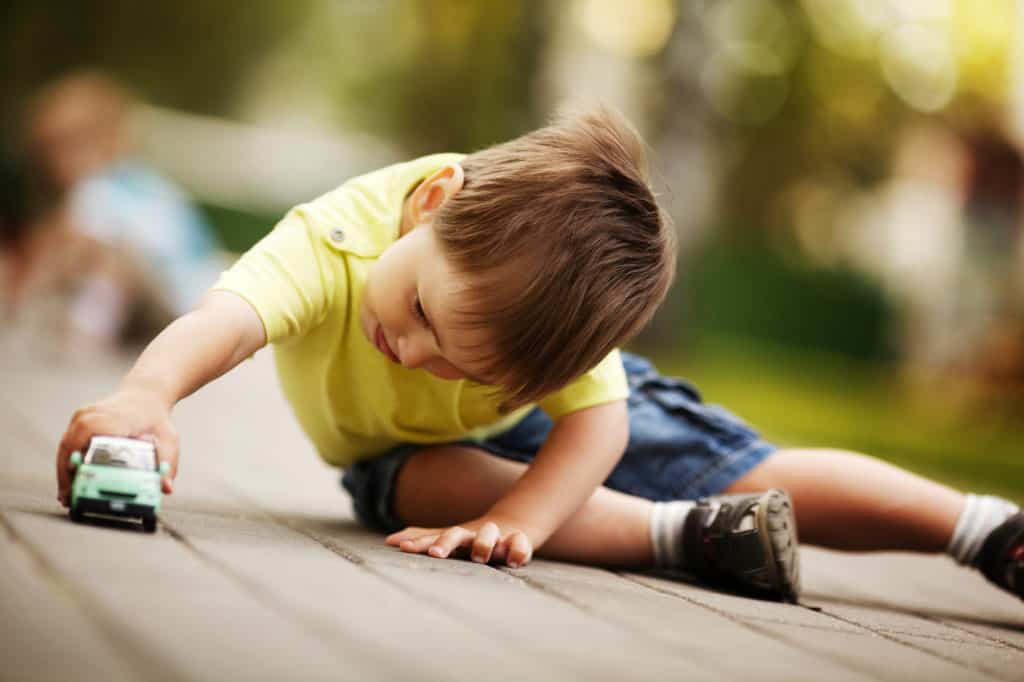 child playing with cars