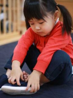 Toddler putting on shoes