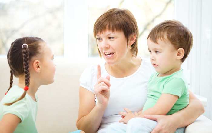 Mom talking to her young children.