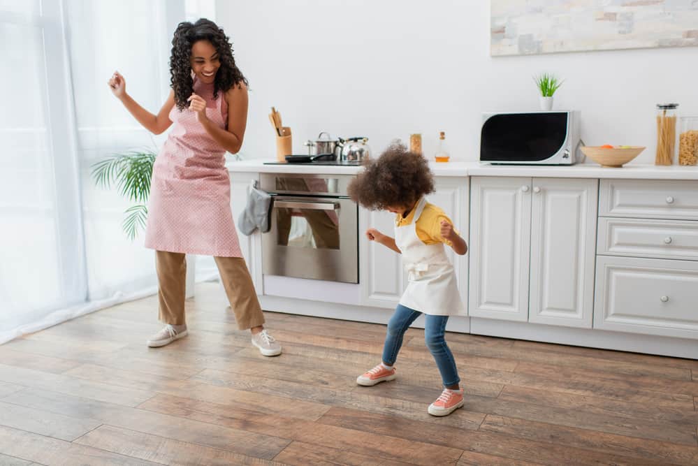 toddler and mom dancing in the kitchen