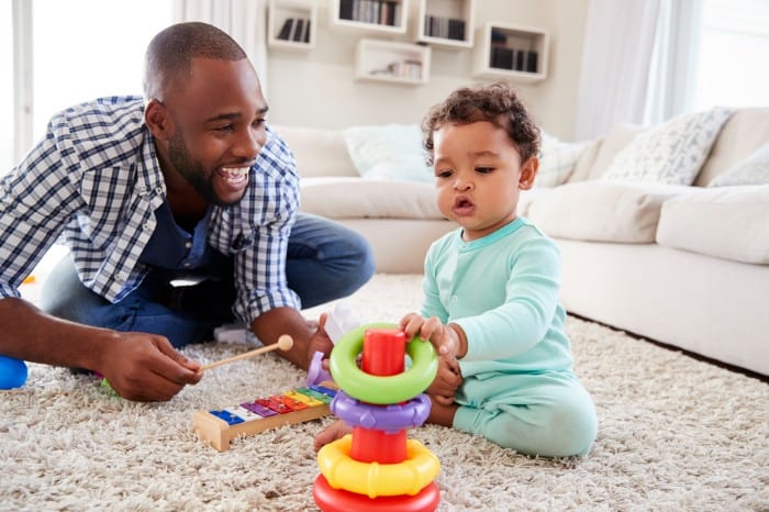 dad playing with toys with his baby