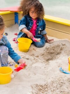 young children playing in sandbox together