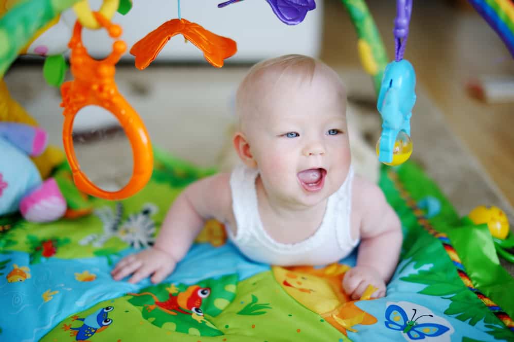 baby doing tummy time on play mat