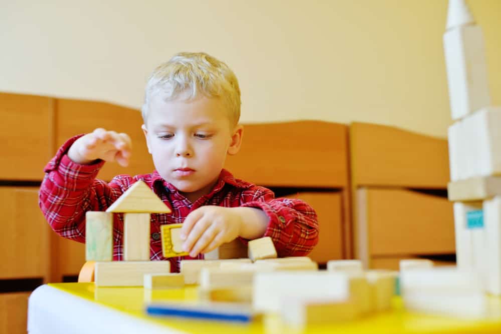 Toddler playing with wooden blocks