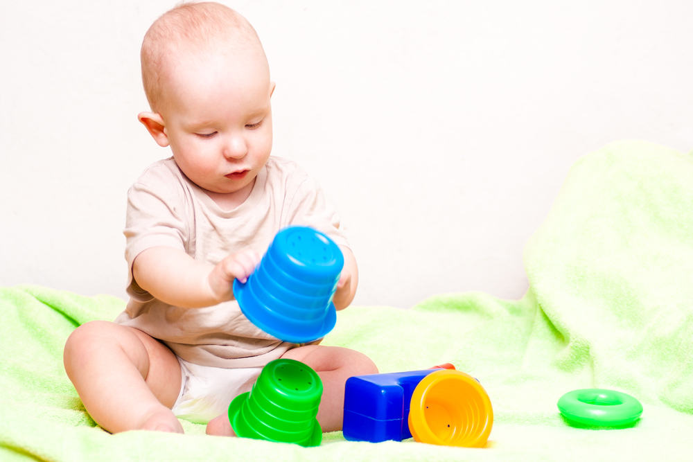 adorable baby playing with colorful toys