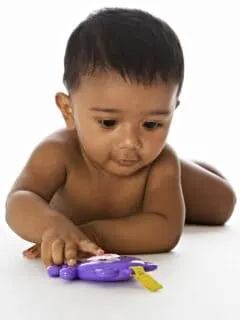 baby playing with toy on tummy