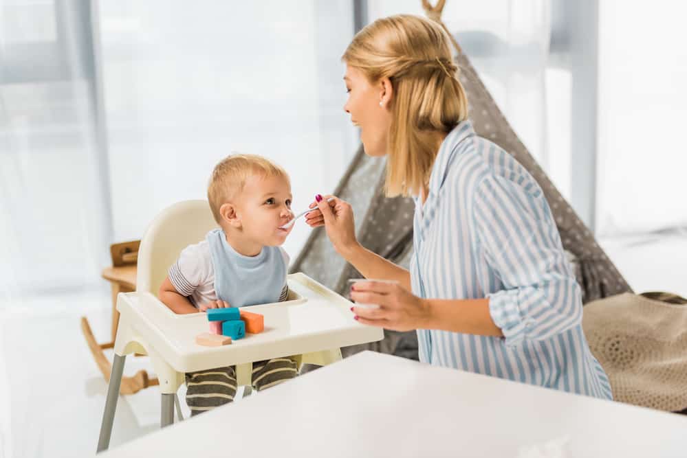 mom feeding toddler