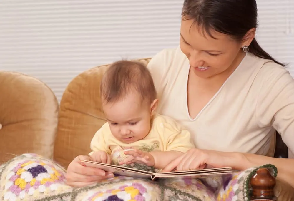 mom reading book to baby