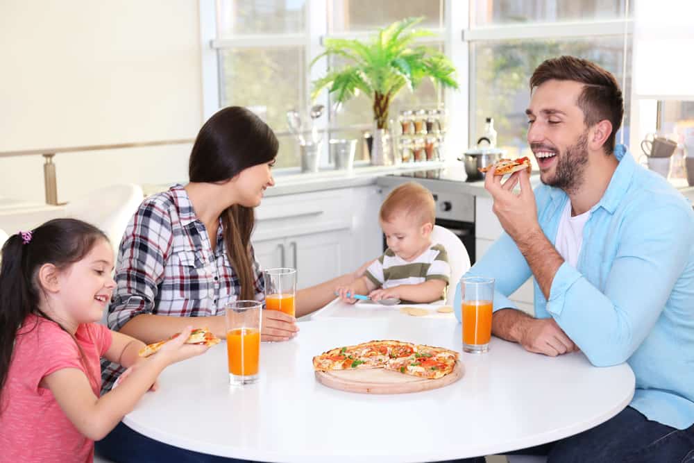 Happy family eating food on kitchen