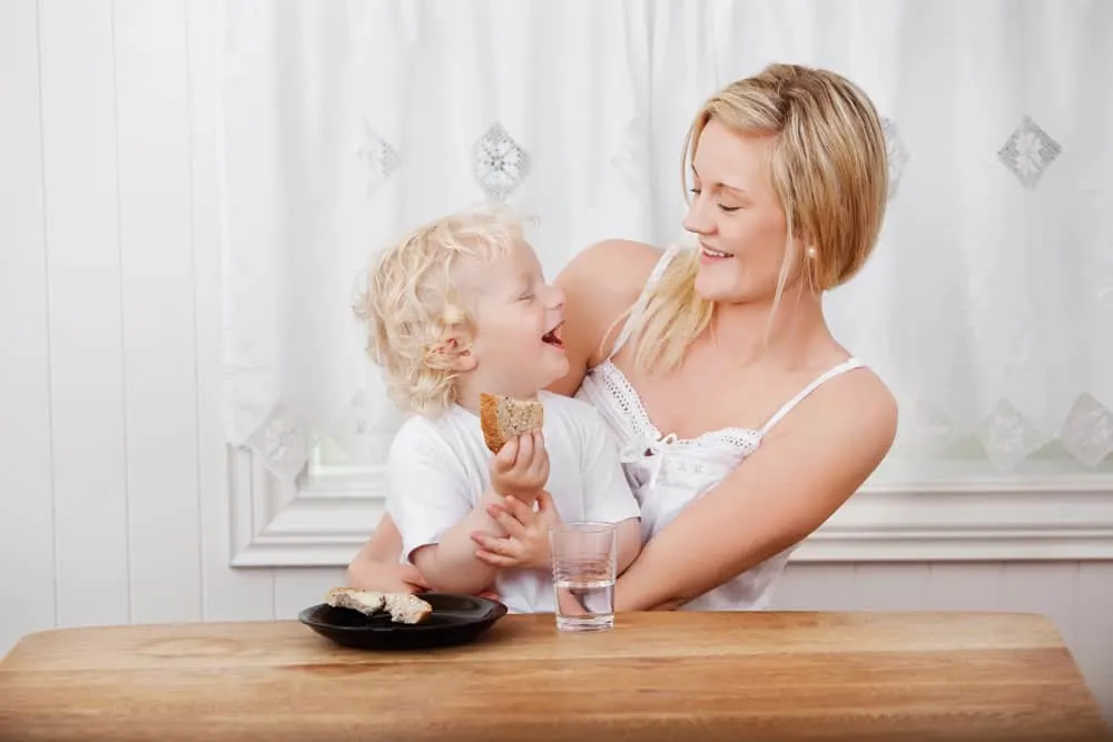 Mom eating a snack with toddler